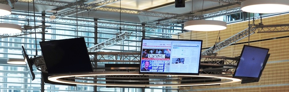 flatscreens in a berlin newsroom 